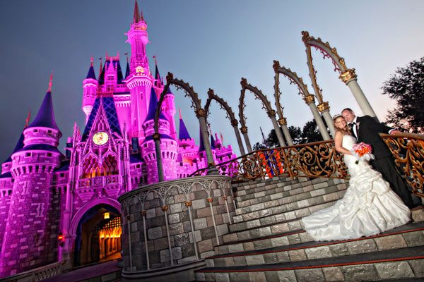 wedding-couple-in-front-of-pink-lit-castle